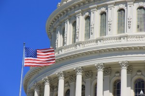 An American flag flying next to the dome of the U.S. Capitol. (Photo credit: Architect of the Capitol)