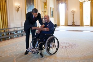 President Obama signs the prosthetic arm of Marine Sgt. Carlos Evans during a tour of the White House for wounded veterans on March 6, 2012. (White House photo by Pete Souza)