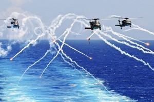 Seahawk helicopters fire flares as they approach the aircraft carrier USS Abraham Lincoln in the Atlantic Ocean, Aug. 2, 2012. (Photo credit: U.S. Navy Seaman Zachary A. Anderson)