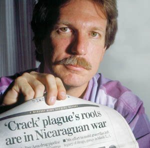 Journalist Gary Webb holding a copy of his Contra-cocaine article in the San Jose Mercury-News., From ImagesAttr