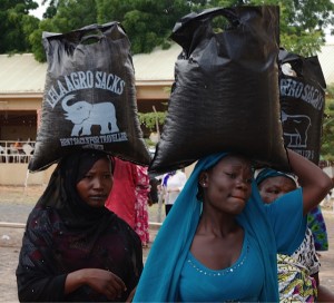 Nigerian refugees from the conflict with Boko Haram carry away supplies. (Photo by Don North)