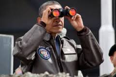 Near the ceasefire line between North and South Korea, President Barack Obama uses binoculars to view the DMZ from Camp Bonifas, March 25, 2012. (Official White House Photo by Pete Souza)