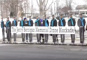 Life-size cut-outs of Jerry Berrigan arrayed to blockade at Hancock  airbase in upstate New York on Jan. 28, 2016. (Screen grab from YouTube video) 