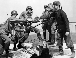 American and Soviet troops symbolically shake hands across the Elbe River on April 25, 1945, in the final days of World War II in Europe.