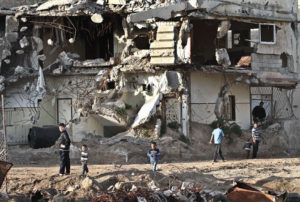 Children play on the ruins of demolished homes in Shejayeh, an area which was heavily hit by Israeli cannon shells and F-16 missiles during Israel’s 51-day war on Gaza in the summer of 2014, when more than 2,200 Palestinians were killed and around 100,000 became homeless. (PHOTO M. OMER)
