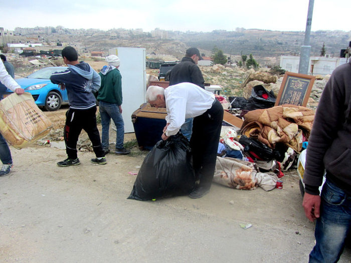 The Idris family in 2014, collecting their belongings after the demolition of their home in Beit Hanina. (Wikimedia) 