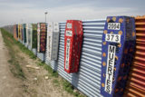 Memorial coffins on the US-Mexico barrier for those killed crossing the border fence in Tijuana, México. (Tomas Castelazo, Wikimedia)