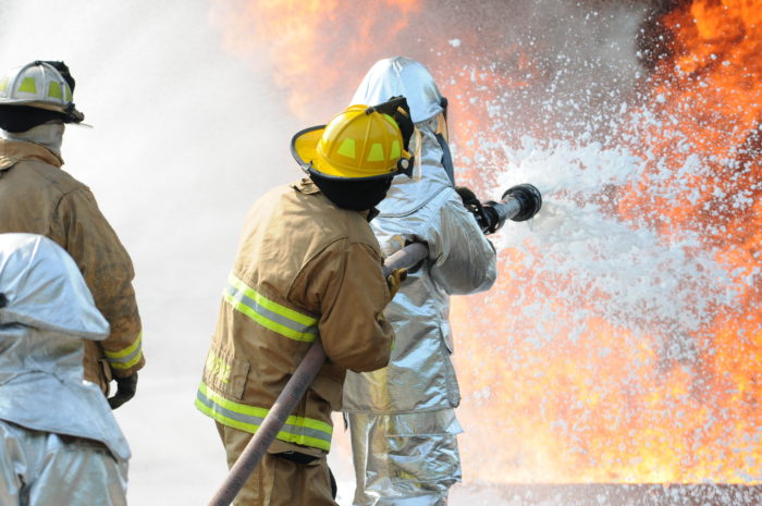 U.S. Air Force and New Jersey state fire protection specialists from the New Jersey Air National Guard's 177th Fighter Wing battle a simulated aircraft fire with Aqueous Film Forming Foam at Military Sealift Command Training Center East in Freehold, N.J. on June 12. Firefighters can spray the foam across the fire blanketing it so the oxygen is cut off and the fire is smothered. Airmen from the Wing hold annual training here to maintain mission readiness. (U.S. Air National Guard photo by Airman 1st Class Amber Powell/Released)
