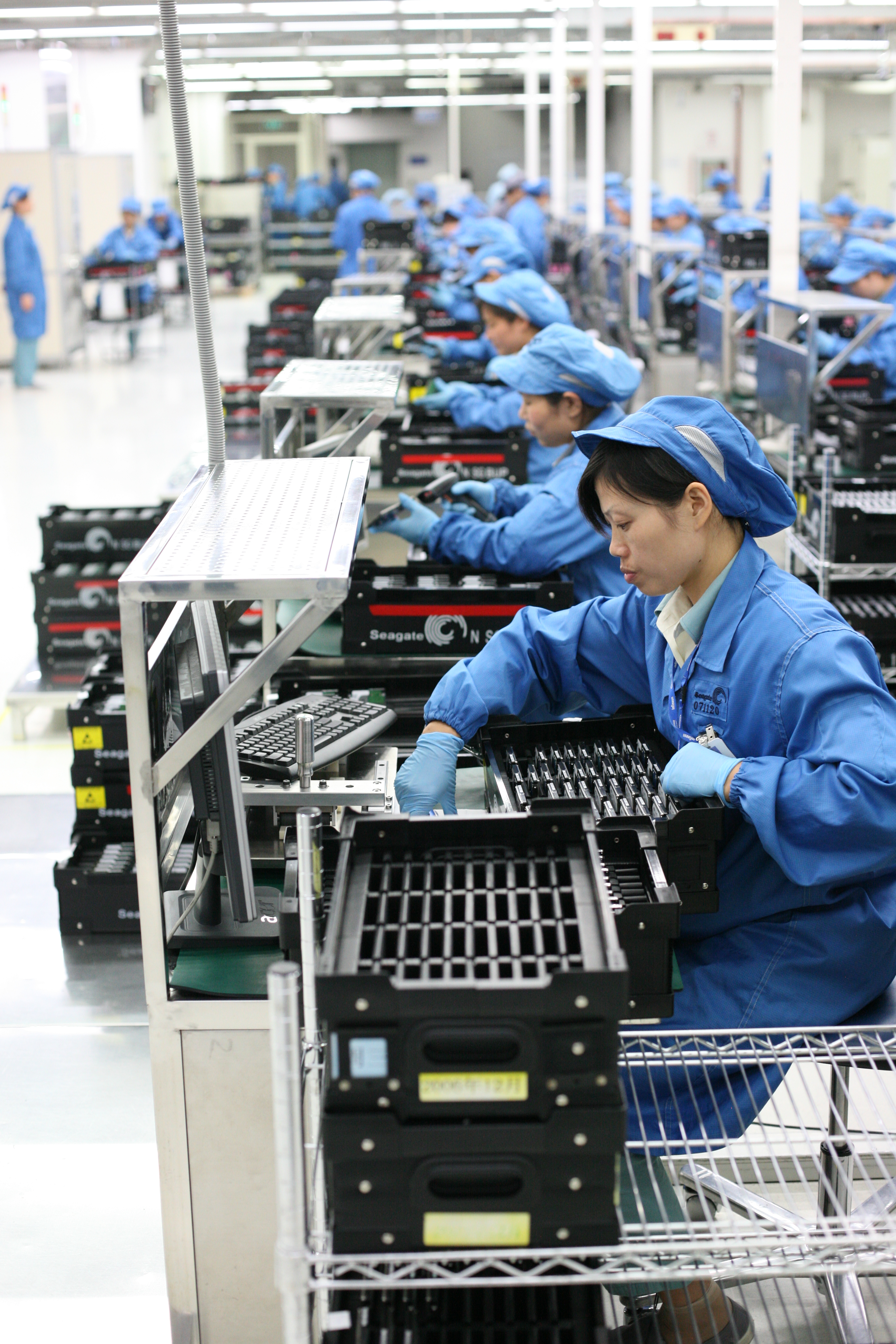 Workers in 2008 perform quality control testing on computer drives; Seagate Wuxi China Factory Tour. (Robert Scoble via Wikimedia)