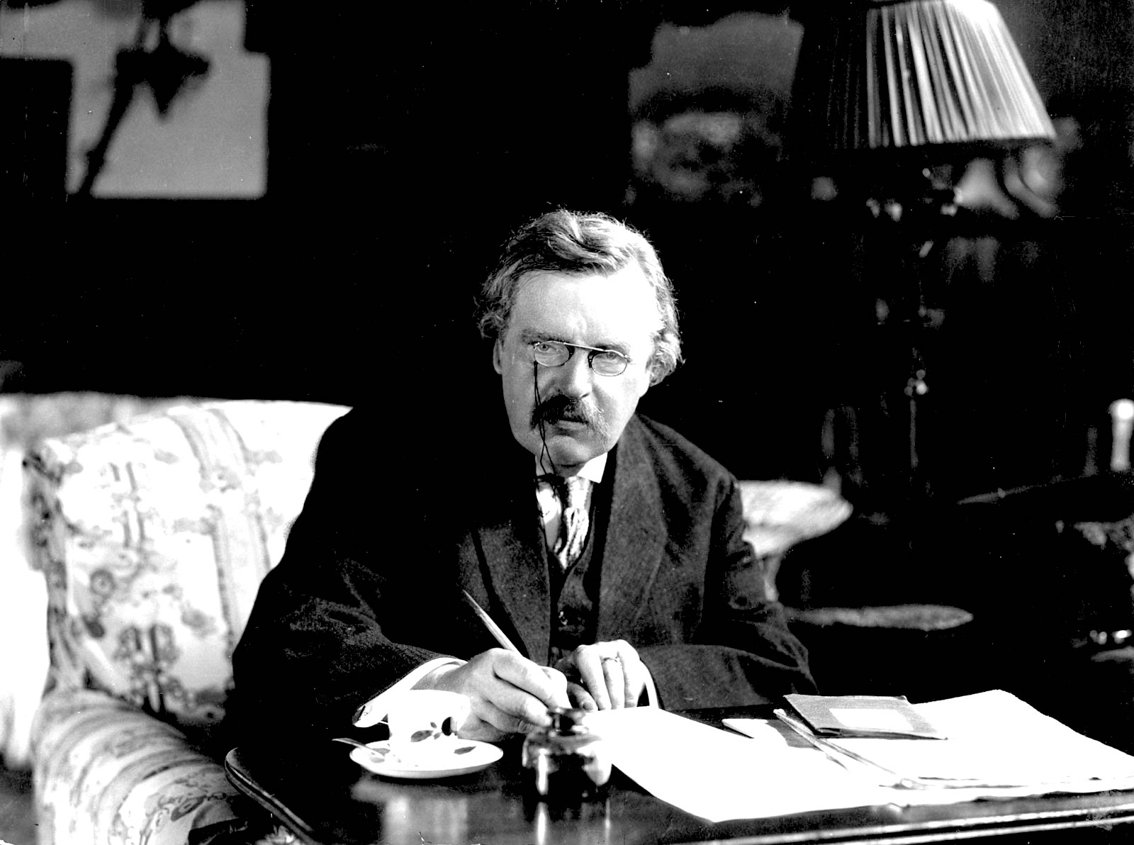 G. K. Chesterton at work, undated. (Wikimedia Commons)