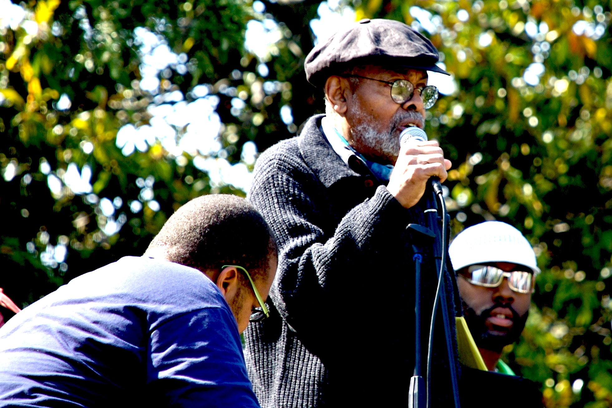Baraka addressing the Malcolm X Festival in San Antonio Park, Oakland, California, while performing with Marcel Diallo and his Electric Church Band, May 2007. Photo: David Sasaki/Wikimedia Commons. 
